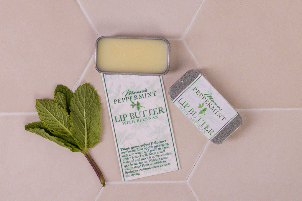 lip butter with beeswax and  peppermint in plastic-free packaging and a seeded paper label