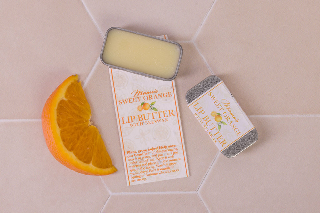 lip butter with beeswax and  sweet orange in plastic-free packaging and a seeded paper label