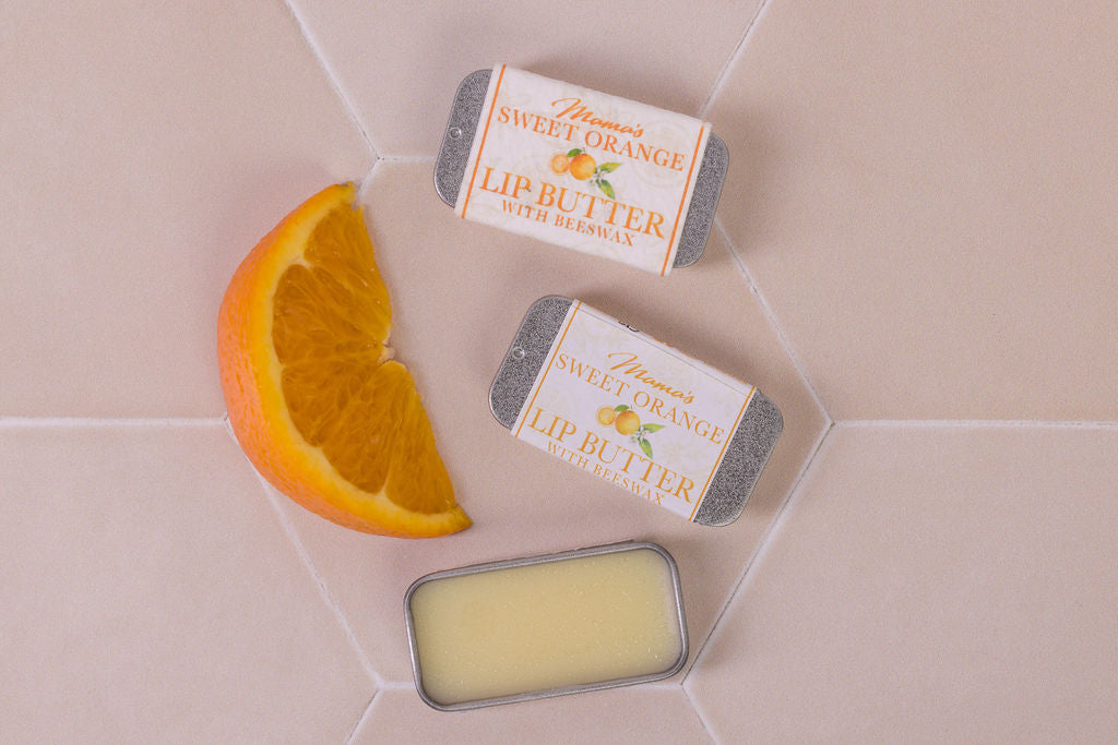 lip butter with beeswax and  sweet orange in plastic-free packaging and a seeded paper label