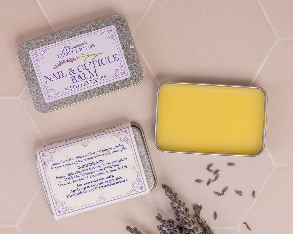 Tin of Mama's nail and cuticle balm displayed with lavender flower heads  on a tiles background