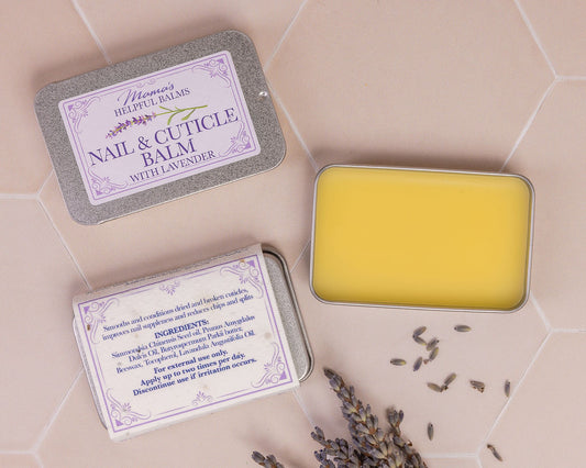 Tin of Mama's nail and cuticle balm displayed with lavender flower heads  on a tiles background