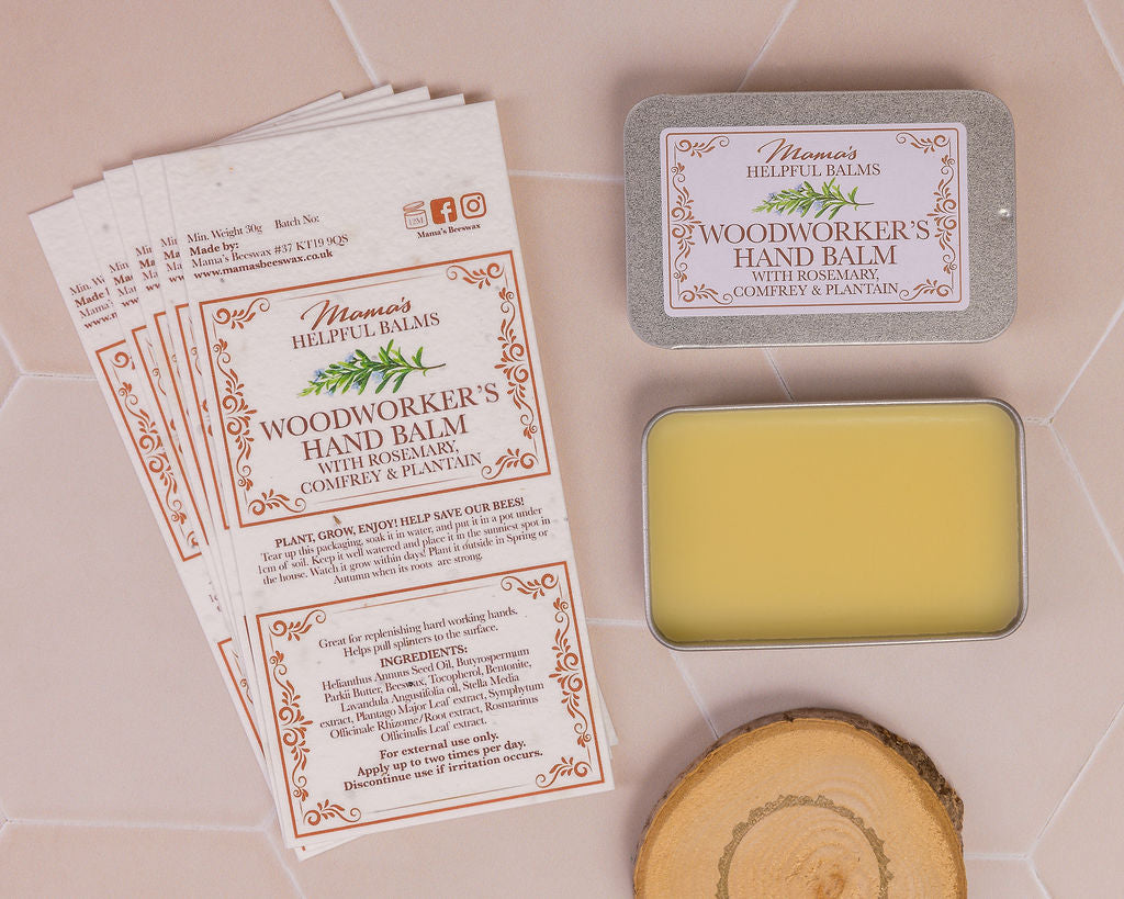 Woodworker's hand balm with display of seeded paper labels and a wood block on a tiled surface