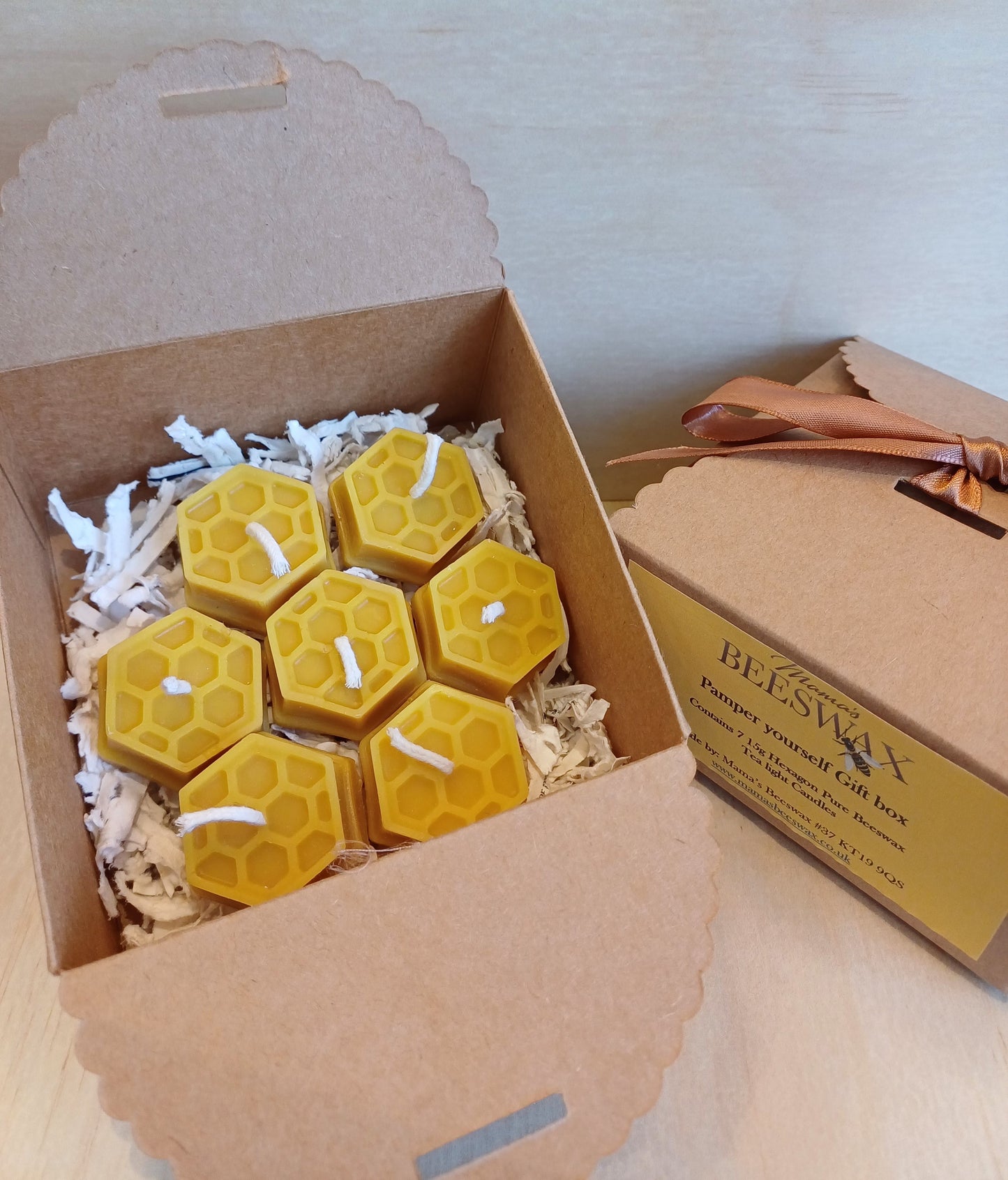 Gift box of 7 pure beeswax tealight candles with a warm golden glow