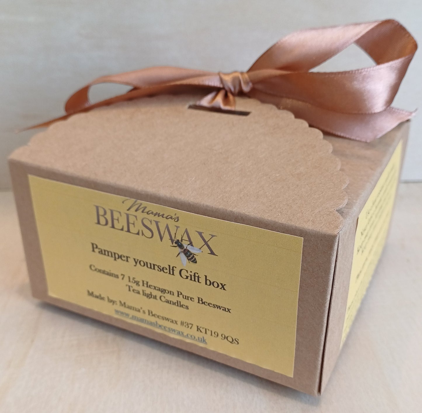 Gift box of 7 pure beeswax tealight candles with a warm golden glow