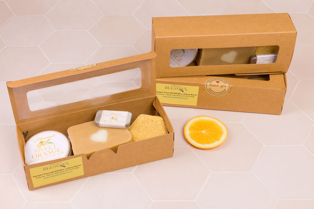 Citrus-themed natural skincare gift box with soap, lotion bar, scrub & lip butter